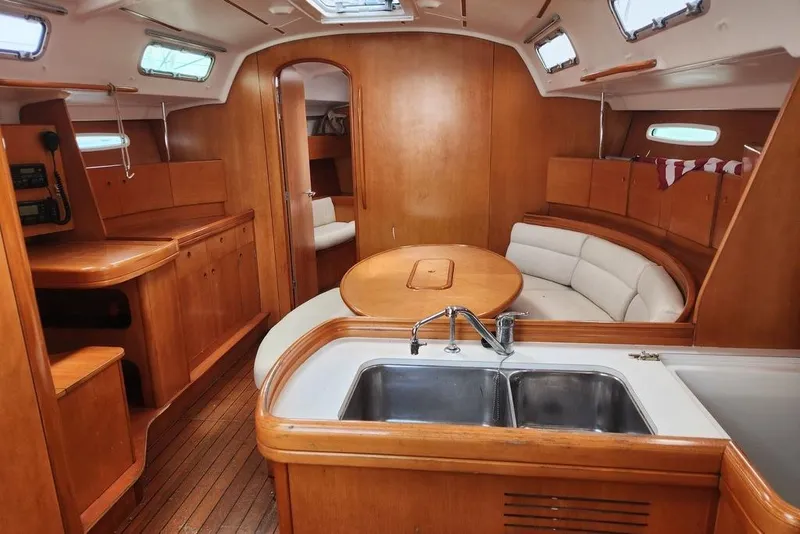 Slide: The Image of Interior of 2005 Beneteau First 44.7 yacht with wood finish and modern amenities. - 21