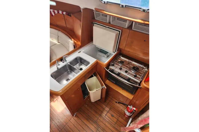 Slide: The Image of Interior of 2005 Beneteau First 44.7 yacht kitchen with sink, stove, and seating area. - 22