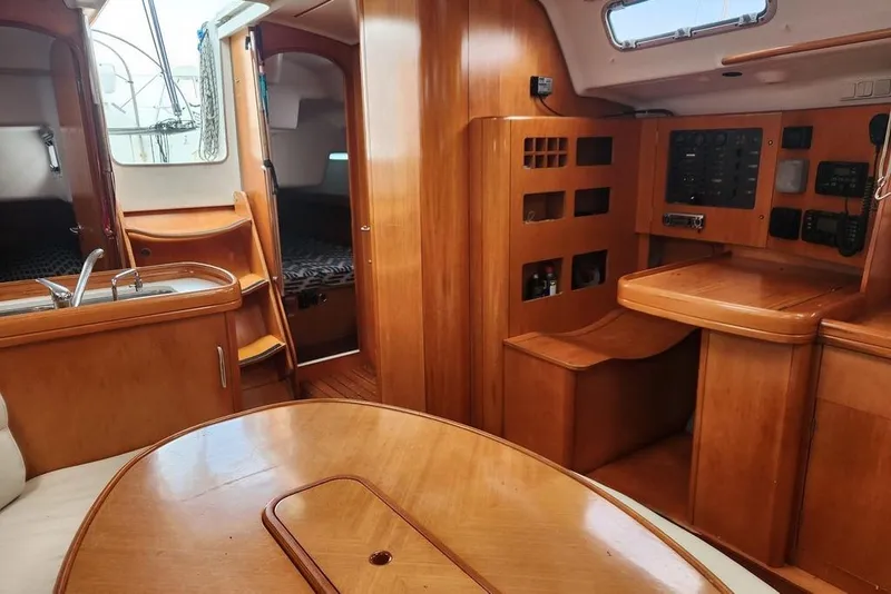 Slide: The Image of Interior of 2005 Beneteau First 44.7 yacht with wood finish and navigation station. - 24