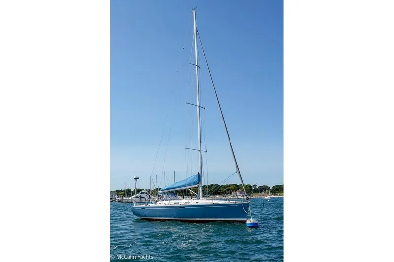 Slide: The Image of 2005 Beneteau First 44.7 sailboat on calm water, clear blue sky background. - 3