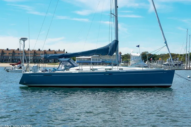 Slide: The Image of 2005 Beneteau First 44.7 sailboat docked in a marina under a clear blue sky. - 5