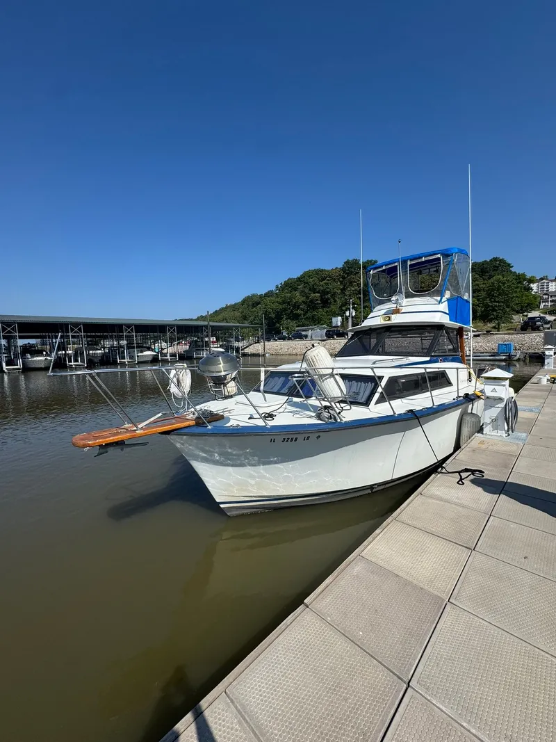 The Image of 1968 Hatteras 31 Flybridge docked on a sunny day. - 0