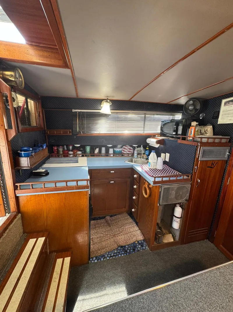Slide: The Image of Interior of 1968 Hatteras 31 Flybridge featuring kitchen area. - 15