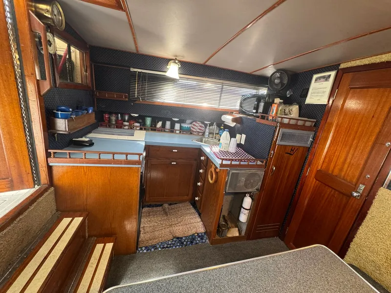 Slide: The Image of 1968 Hatteras 31 Flybridge interior with wooden cabinetry. - 16