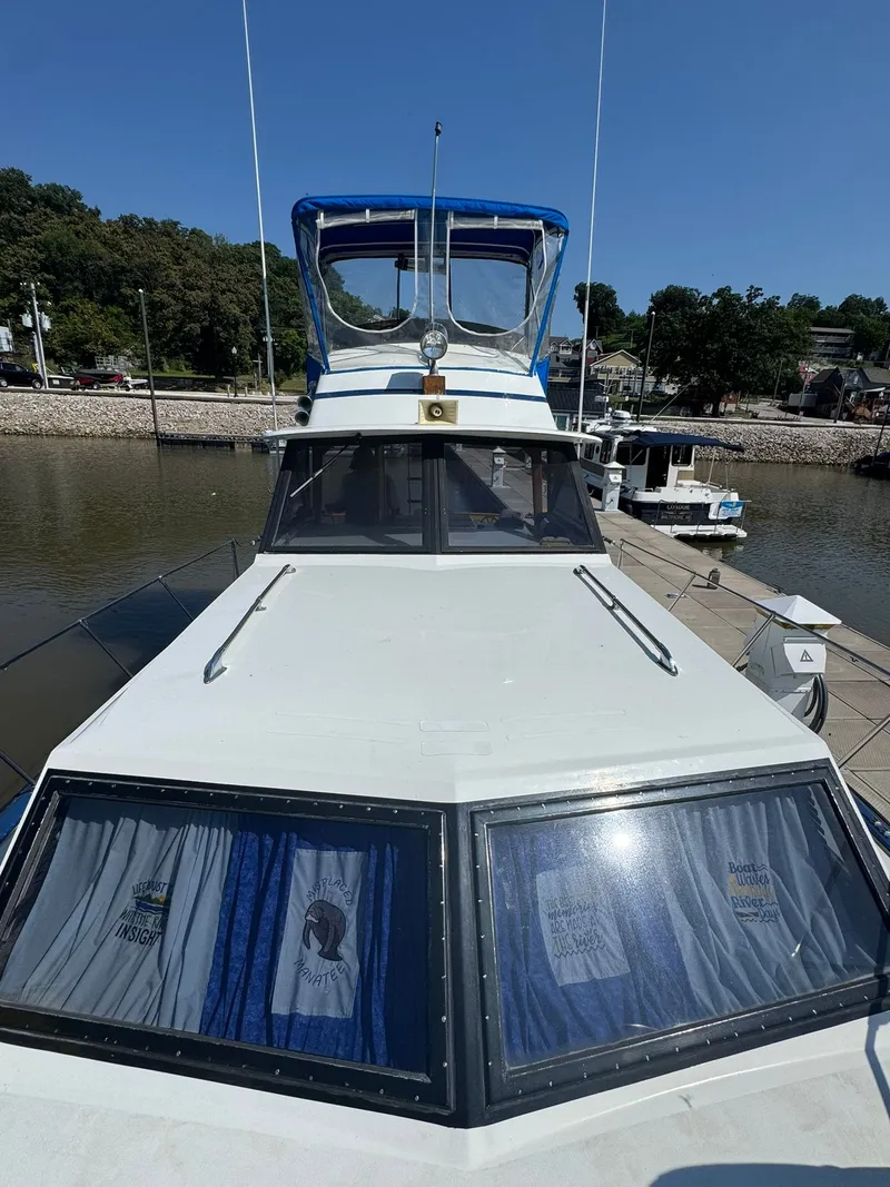 Slide: The Image of 1968 Hatteras 31 Flybridge boat docked on a sunny day. - 3