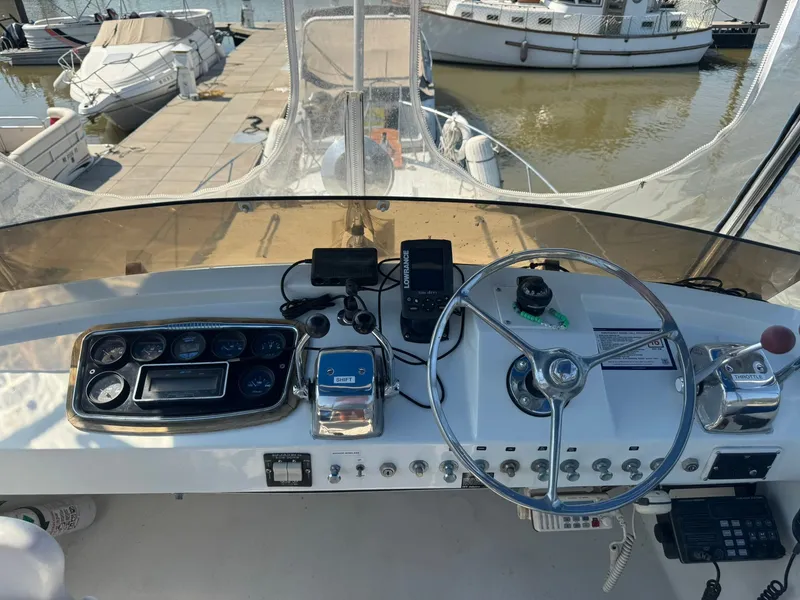 Slide: The Image of Helm of a 1968 Hatteras 31 Flybridge at the marina. - 8