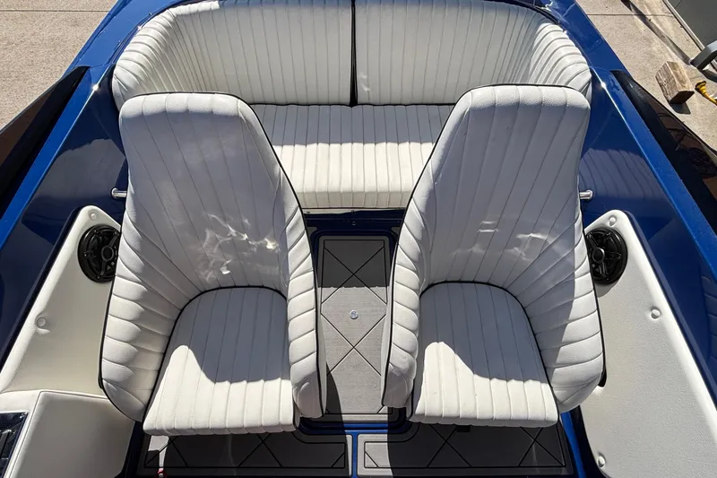 Slide: The Image of Interior of 2026 Donzi 22 Classic boat with white cushioned seats and blue accents. - 11
