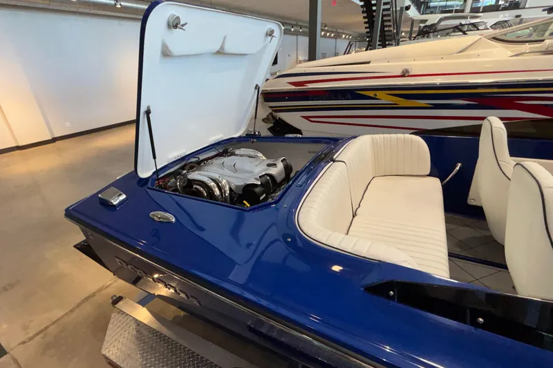 Slide: The Image of 2026 Donzi 22 Classic boat with open engine compartment, blue exterior, and white seating. - 13