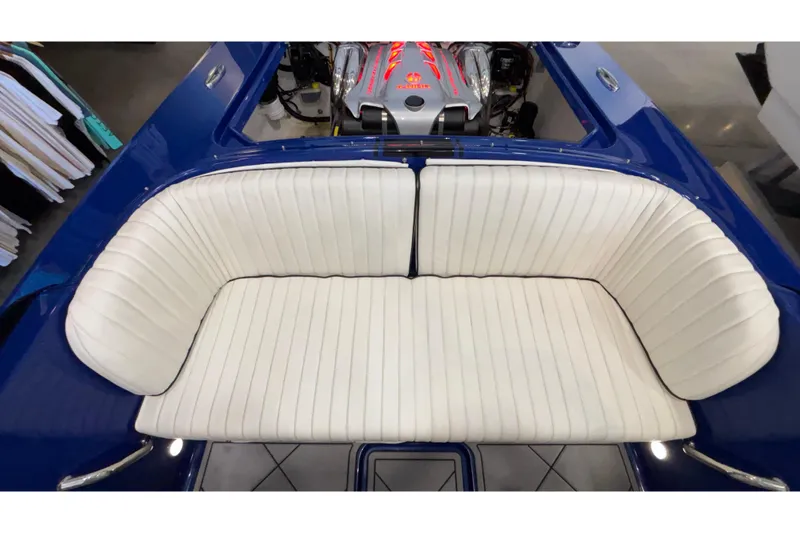 Slide: The Image of Interior of 2026 Donzi 22 Classic boat with white seating and visible engine. - 17