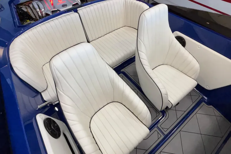 Slide: The Image of 2026 Donzi 22 Classic boat interior with white leather seats and blue accents. - 20