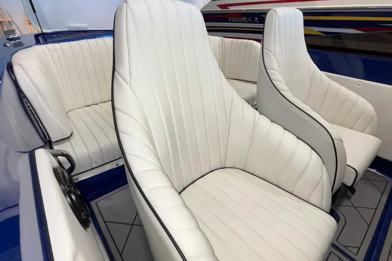 Slide: The Image of 2026 Donzi 22 Classic boat interior with white leather seats and blue accents. - 21