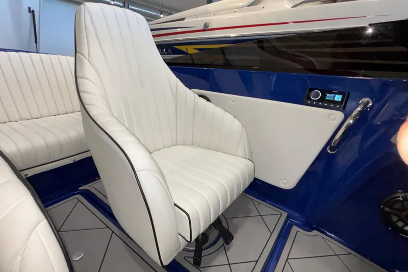 Slide: The Image of Interior of 2026 Donzi 22 Classic boat with white seating and blue accents. - 22