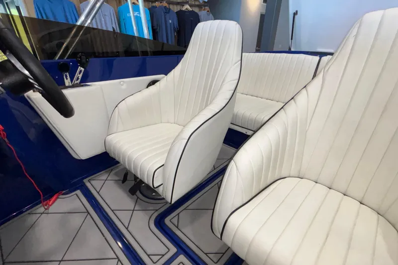 Slide: The Image of 2026 Donzi 22 Classic boat interior with white leather seats and blue accents. - 23