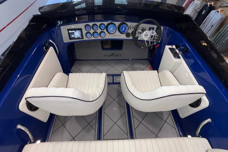 Slide: The Image of Interior of 2026 Donzi 22 Classic boat with white seats and modern dashboard. - 24