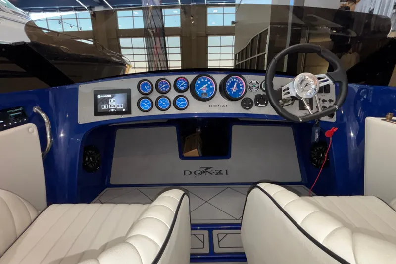 Slide: The Image of Interior of 2026 Donzi 22 Classic boat with modern dashboard and steering wheel. - 25