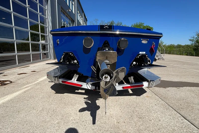 Slide: The Image of 2026 Donzi 22 Classic boat rear view with propeller, parked outdoors. - 3