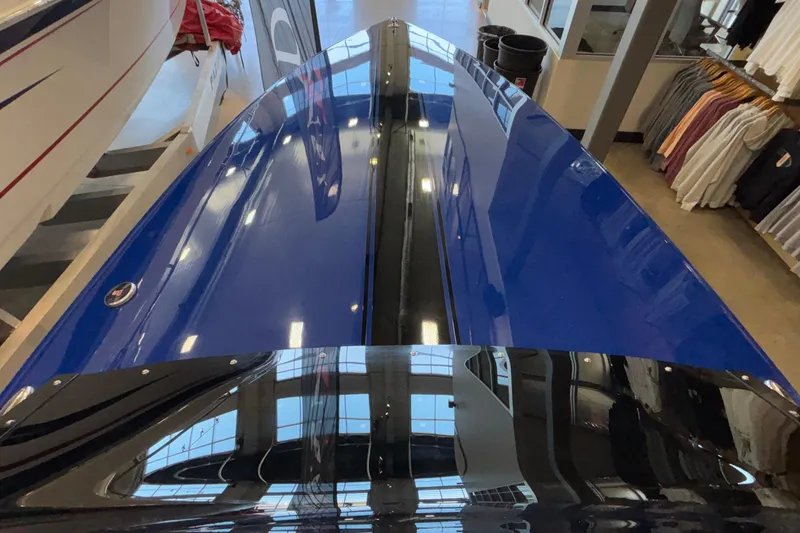 Slide: The Image of 2026 Donzi 22 Classic boat with sleek blue and black finish in showroom. - 30