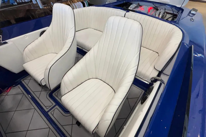 Slide: The Image of 2026 Donzi 22 Classic boat interior with white leather seats and blue accents. - 31