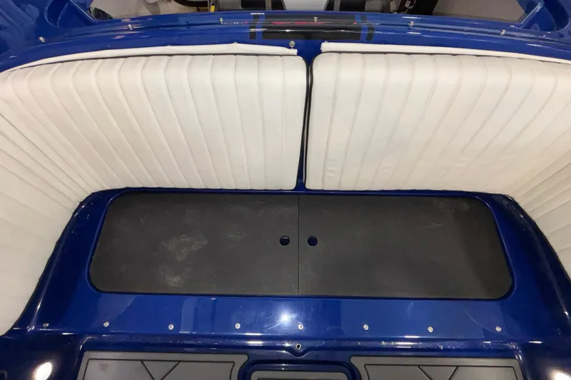 Slide: The Image of Interior view of a 2026 Donzi 22 Classic boat with white seating and blue accents. - 32
