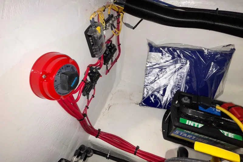 Slide: The Image of Electrical setup in a 2026 Donzi 22 Classic boat, featuring wiring and battery components. - 35