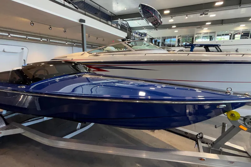 Slide: The Image of 2026 Donzi 22 Classic boat in showroom, featuring sleek blue design. - 37