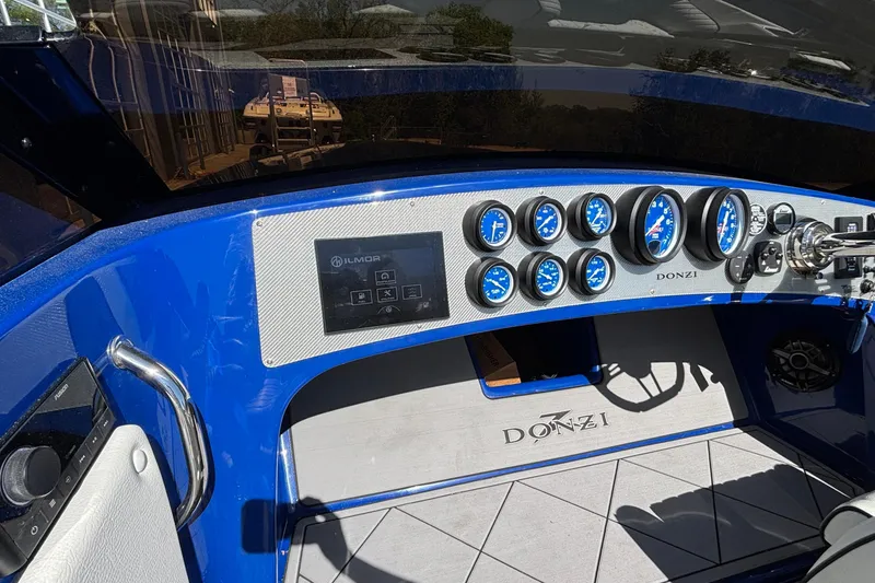 Slide: The Image of Cockpit of 2026 Donzi 22 Classic boat with blue gauges and steering wheel. - 5
