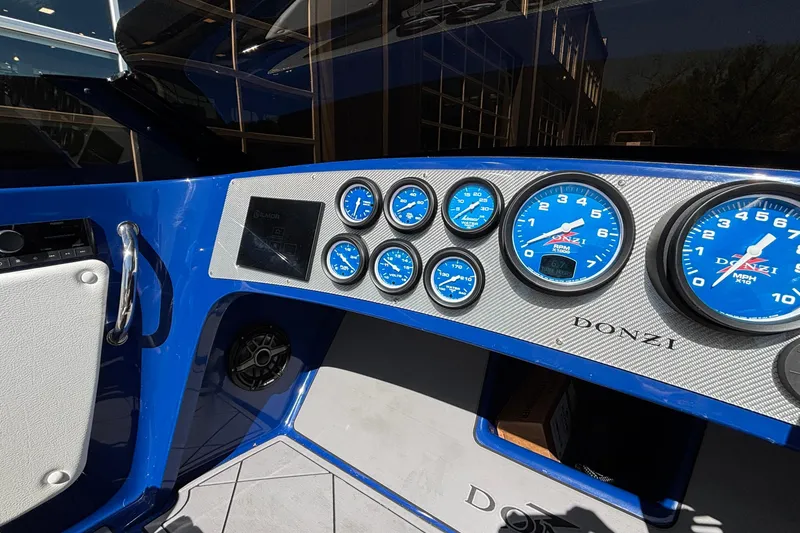 Slide: The Image of Dashboard of 2026 Donzi 22 Classic boat with blue gauges and modern controls. - 6