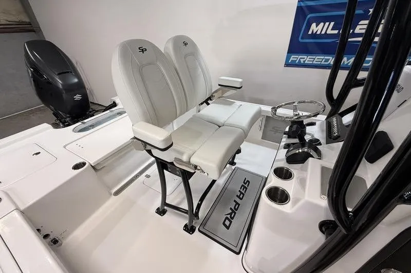 Slide: The Image of 2026 Sea Pro 250 Bay boat interior with dual seats and steering console. - 10