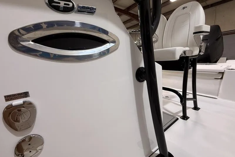 Slide: The Image of 2026 Sea Pro 250 Bay boat interior with seating and freshwater access. - 12