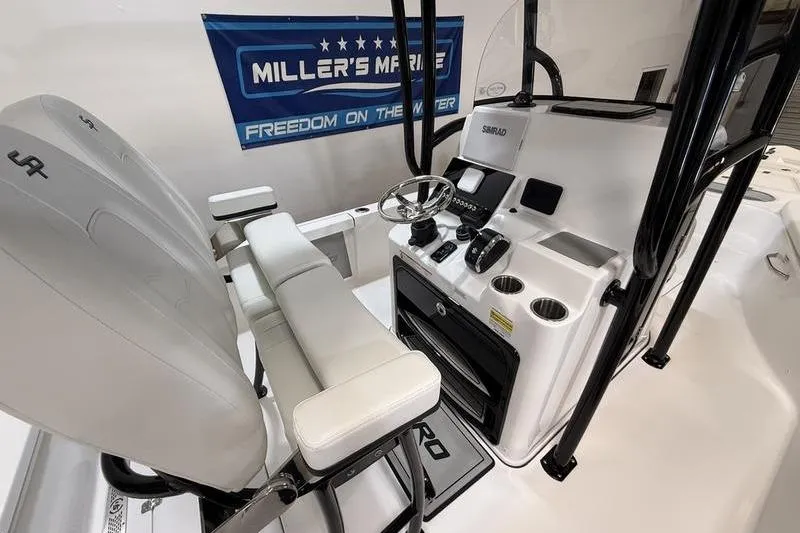 Slide: The Image of 2026 Sea Pro 250 Bay boat interior with helm, seating, and controls. - 13
