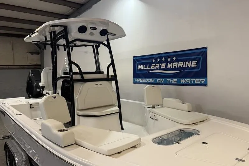 Slide: The Image of 2026 Sea Pro 250 Bay boat displayed indoors at Miller's Marine showroom. - 16