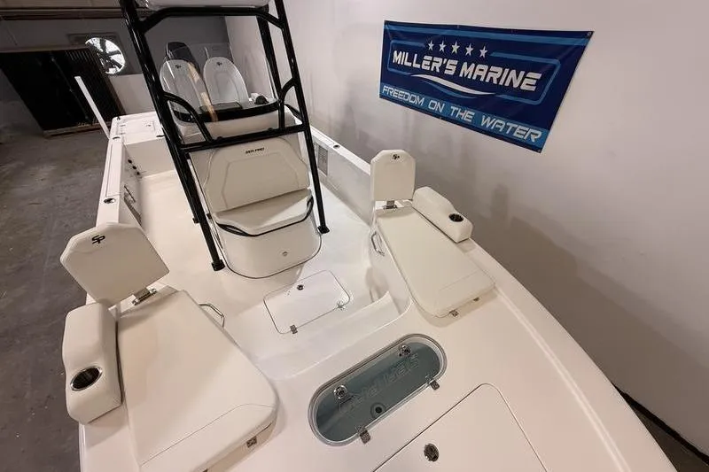 Slide: The Image of 2026 Sea Pro 250 Bay boat interior with seating and storage, displayed at Miller's Marine. - 17