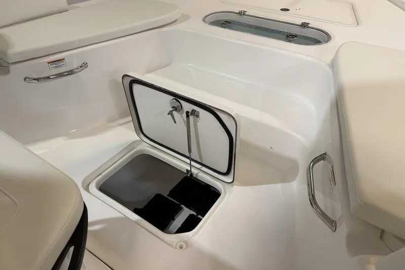 Slide: The Image of 2026 Sea Pro 250 Bay boat interior storage compartment with open hatch and seating. - 19