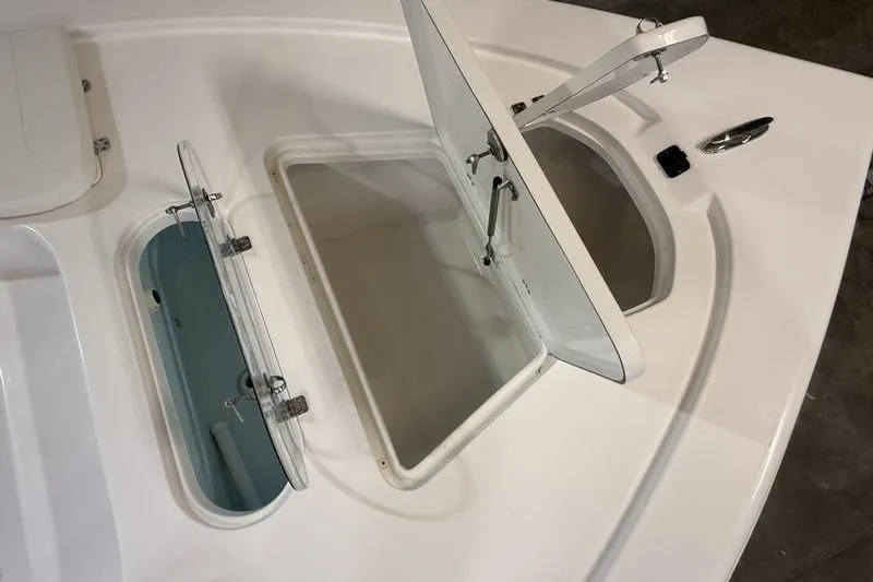 Slide: The Image of Open storage compartments on a 2026 Sea Pro 250 Bay boat deck. - 20