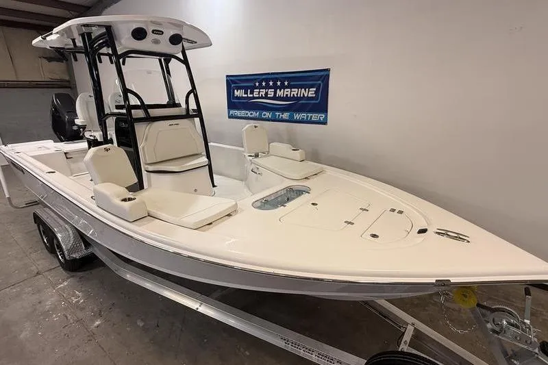 Slide: The Image of 2026 Sea Pro 250 Bay boat displayed indoors at Miller's Marine showroom. - 3