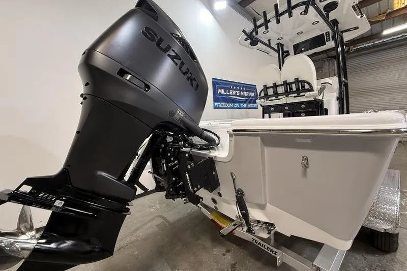 Slide: The Image of 2026 Sea Pro 250 Bay boat with Suzuki outboard motor in a showroom. - 4