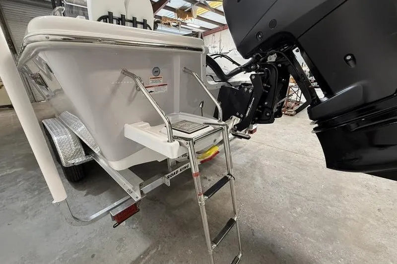Slide: The Image of 2026 Sea Pro 250 Bay boat with ladder and motor in a warehouse. - 5