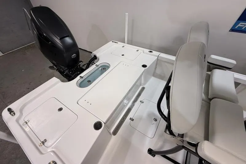 Slide: The Image of 2026 Sea Pro 250 Bay boat interior with seating and motor, showcasing modern design. - 6