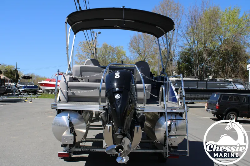 Slide: The Image of 2026 Barletta ARIA 22UC pontoon boat with outboard motor, parked outdoors. - 4