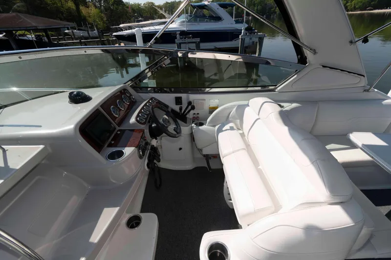 Slide: The Image of 2004 Formula 330 Sun Sport boat interior with white seating and control panel. - 10