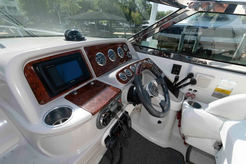 Slide: The Image of Dashboard of a 2004 Formula 330 Sun Sport boat with steering wheel and gauges. - 11