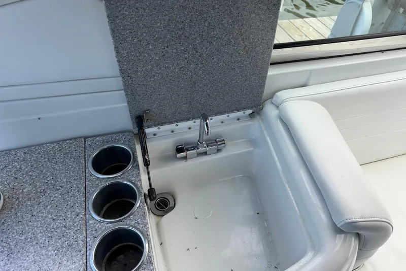 Slide: The Image of 2004 Formula 330 Sun Sport boat sink with faucet and cup holders. - 12