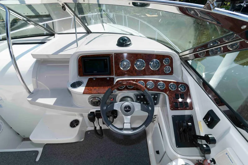 Slide: The Image of Cockpit of 2004 Formula 330 Sun Sport boat with steering wheel and instrument panel. - 13