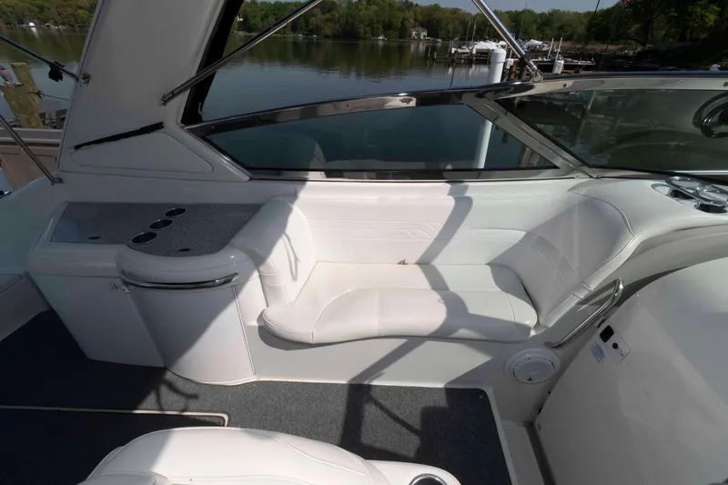 Slide: The Image of 2004 Formula 330 Sun Sport boat interior with white seating and lake view. - 15