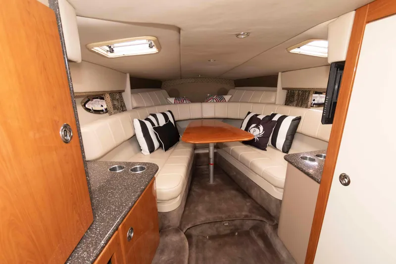 Slide: The Image of Interior of 2004 Formula 330 Sun Sport boat with plush seating and wooden table. - 16