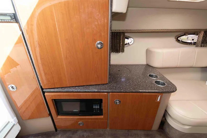 Slide: The Image of Interior of 2004 Formula 330 Sun Sport with wood cabinetry and microwave. - 19