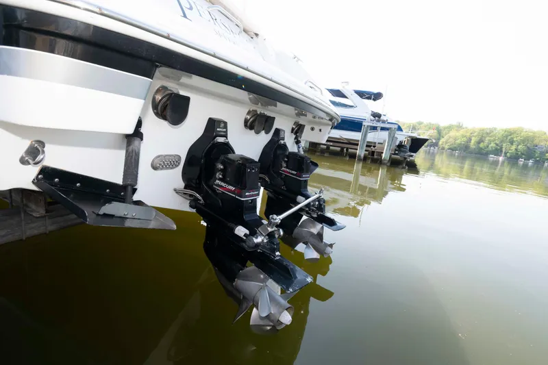 Slide: The Image of 2004 Formula 330 Sun Sport boat with dual Mercury outboard motors docked on a calm lake. - 22