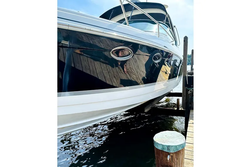 Slide: The Image of 2004 Formula 330 Sun Sport boat docked at marina, reflecting water and sky. - 6
