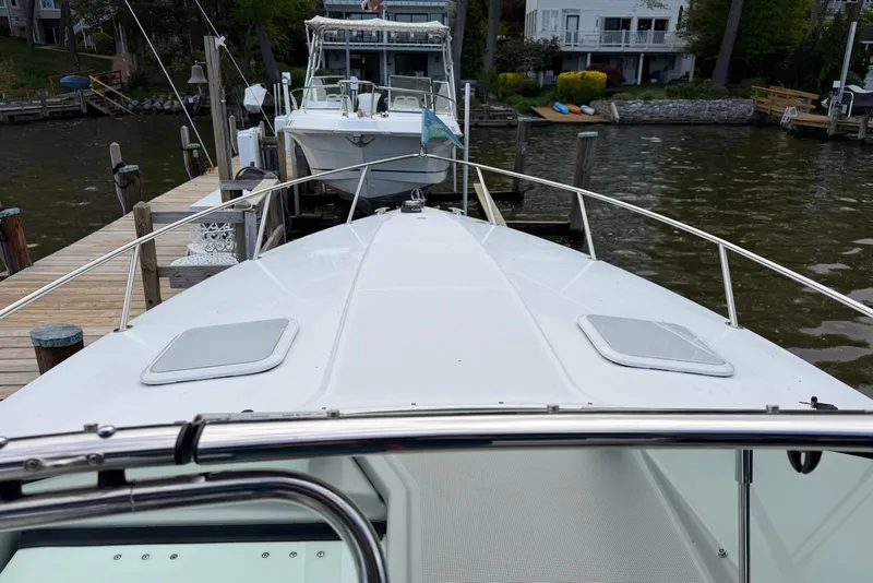 Slide: The Image of 2004 Formula 330 Sun Sport docked at a marina, viewed from the bow. - 8