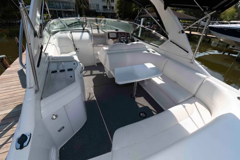 Slide: The Image of 2004 Formula 330 Sun Sport boat interior with white seating and helm. - 9